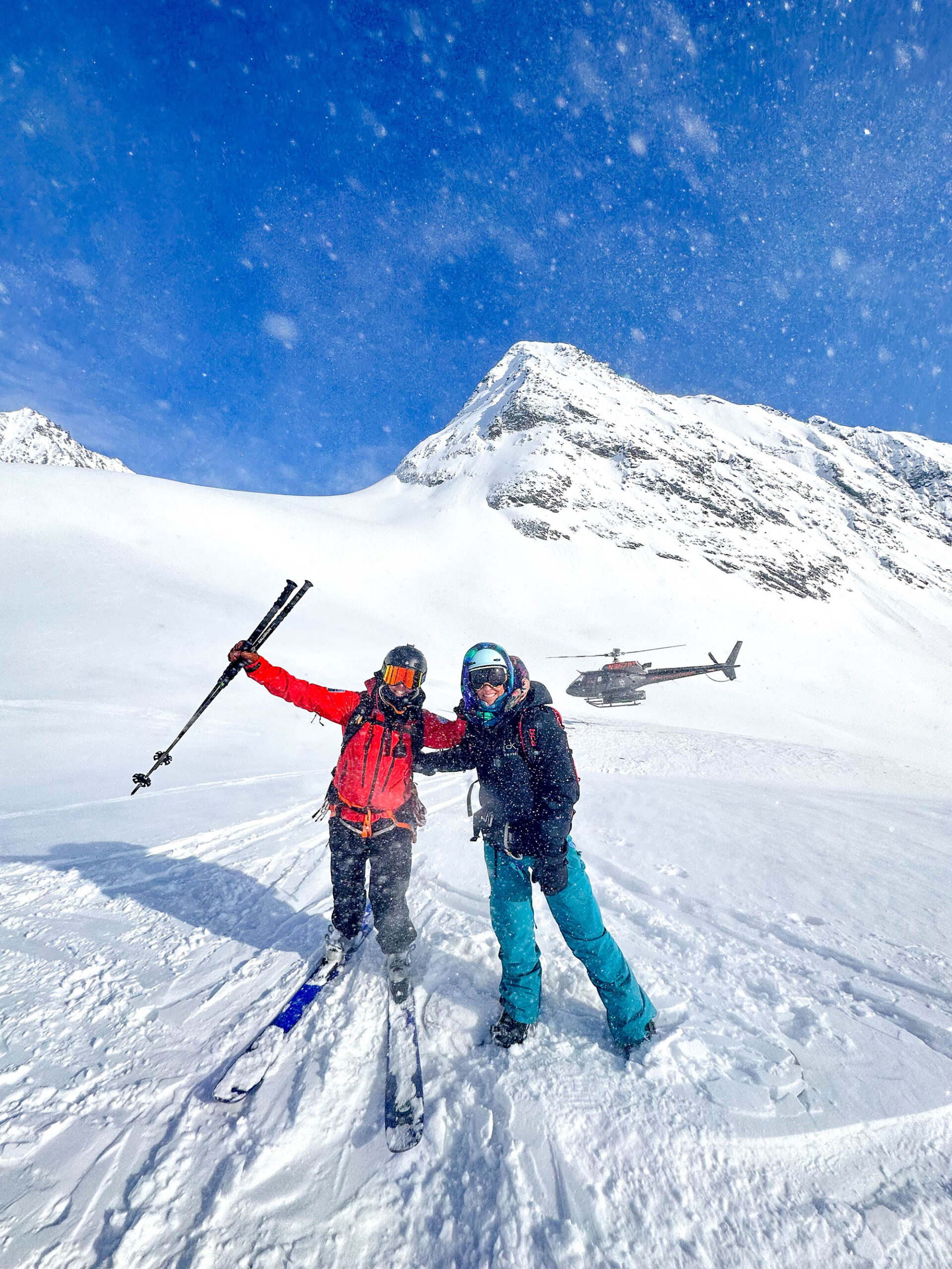 Majestic Heli Ski Guide with client on snow.